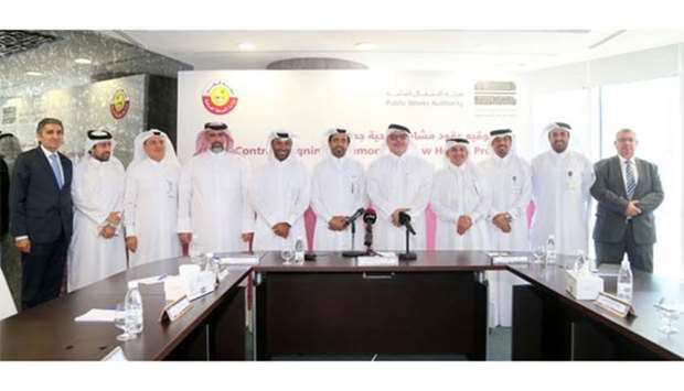 Ashghal president Saad bin Ahmed al-Muhannadi (fifth from right) and PHCC's Dr Musallam al-Nabit (sixth from left) with other Ashghal officials and representatives of companies that were awarded contracts on Sunday: PICTURE: Jayan Orma