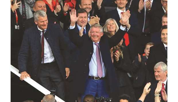 Former Manchester United manager Alex Ferguson waves to the crowd as he arrives at Old Trafford in Manchester yesterday.
