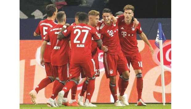 Bayern Munichu2019s James Rodriguez (second from right) celebrates his goal with teammates during the Bundesliga match against Schalke 04 at Veltins-Arena in Gelsenkirchen, Germany, yesterday. (Reuters)