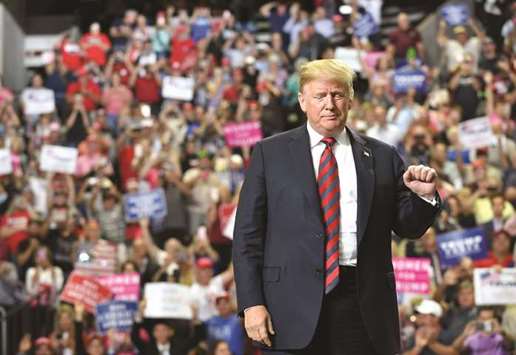 President Donald Trump arrives on stage to speak at a rally at JQH Arena in Springfield, Missouri, on Friday evening.