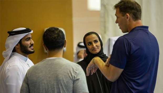 HE Sheikha Hind bint Hamad al-Thani and HE Sheikh Mohamed bin Hamad al-Thani interacting with one of the NBA stars.
