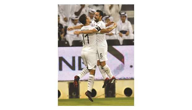 Al Saddu2019s Baghdad Bounedjah and captain Xavi celebrate after the former scored against Al Rayyan yesterday. PICTURE: Noushad Thekkayil