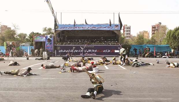 This picture taken yesterday in the southwestern Iranian city of Ahvaz shows injured soldiers lying on the ground at the scene of an attack on a military parade that was marking the anniversary of the outbreak of its devastating 1980-1988 war with Saddam Husseinu2019s Iraq.