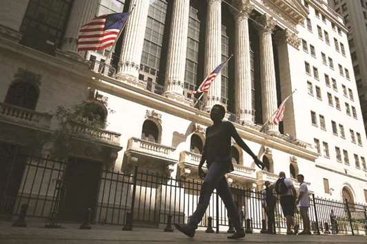 People walk by the New York Stock Exchange (file). The S&P Dow Jones Indices will reorganise several of its sectors and relaunch its telecommunications index as a new communication services sector.