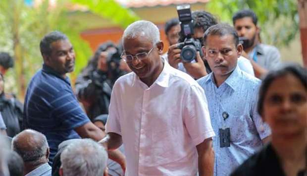 Opposition candidate for president Ibrahim Mohamed Solih arrives at a polling station in Male on Sunday.