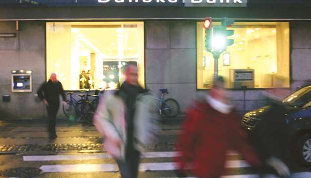 Pedestrians walk past a Danske Bank branch in Copenhagen. Danske Bank has admitted that about $234bn flowed through a tiny unit in Estonia between 2007 and 2015, and is treating a u201clargeu201d share of that amount as u201csuspiciousu201d transactions.