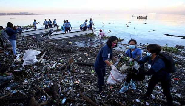 Volunteers participate in collecting garbage from Manila bay during the 33rd International Coastal Cleanup in Manila.