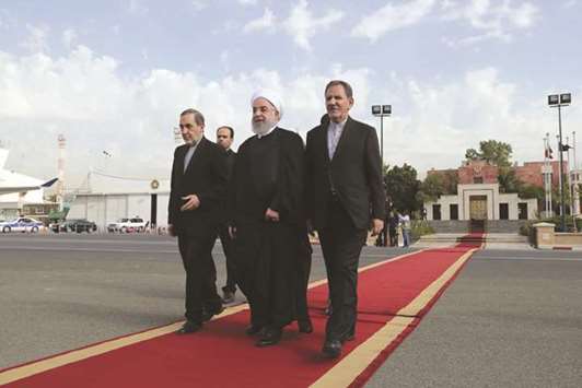 A handout picture provided shows Iranian President Hassan Rouhani and Vice president Eshaq Jahangiri (right) and Ali Akbar Velayati (left), foreign policy adviser to Iran supreme leader, during a farewell ceremony at the Mehrabad airport in Tehran, shortly before leaving for the UN General Assembly in New York.