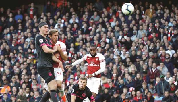 Arsenalu2019s French striker Alexandre Lacazette (right) scores against Everton during the English Premier match in London. (AFP)