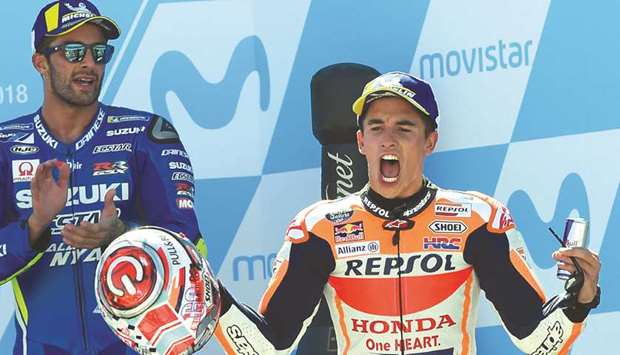 Repsol Honda rider Marc Marquez celebrates his win in the MotoGP of Aragon on the podium at the Motorland circuit in Alcaniz, Spain, yesterday. (AFP)