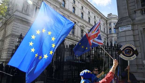 An anti-Brexit demonstrator holds a flag outside Downing Street in London, Britain
