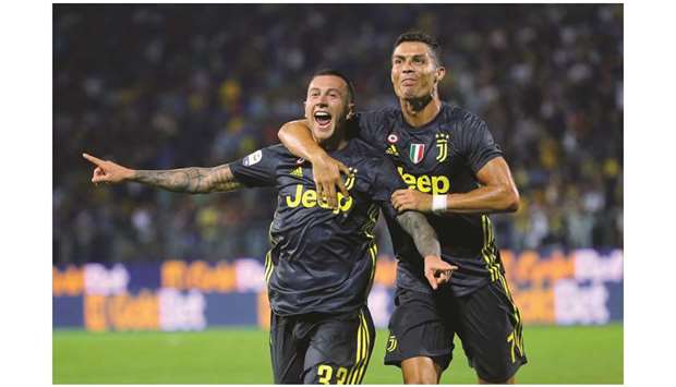Juventusu2019 Federico Bernardeschi (left) celebrates with Cristiano Ronaldo after scoring against Frosinone on Sunday night. (Reuters)