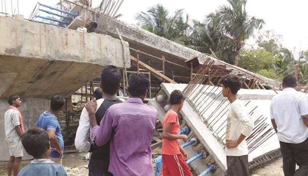 Onlookers stand near the under-construction bridge that collapsed in South 24 Parganas yesterday.