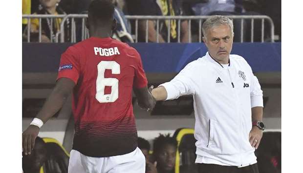 Paul Pogba has captained Manchester United three times this season but Jose Mourinho (right) has been unimpressed by the midfielderu2019s performances. (AFP)
