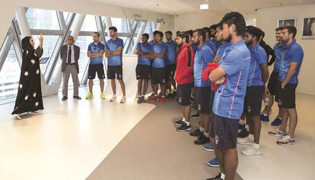 Delhi Dynamos players  listen to a presentation at  the Supreme Committeeu2019s  office in Doha.