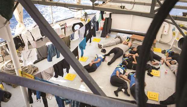 A handout photo released on Monday by SOS Mediterranee shows migrants resting after being rescued last week by the Aquarius rescue ship, run by non-governmental organisations u2018SOS Mediterraneeu2019 and Medecins Sans Frontieres (MSF, Doctors without Borders) in the search and rescue zone off the coast of Libya, in the Mediterranean Sea.