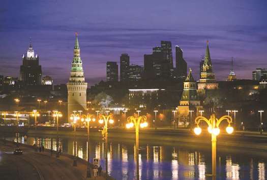The skyscrapers of the Moscow International Business Center, also known as u2018Moscow City,u2019 (centre), stand on the skyline beyond the Kremlin and Moskva River in Moscow. US sanctions will weigh on Russiau2019s economic growth but are unlikely to imminently deprive Moscow of its investment-grade rating, the head of Fitch Ratings Sovereigns group said yesterday.