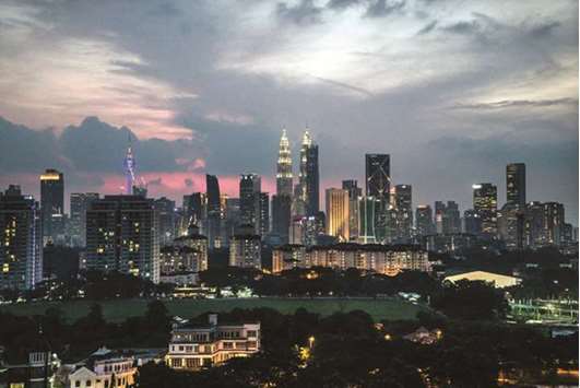 Buildings stand illuminated at dusk in Kuala Lumpur (file). Regulators overseeing Islamic banking must revise guidance on real estate exposures to align with the post-financial crisis capital rules of Basel III, according to the General Council for Islamic Banks and Financial Institutions (CIBAFI).