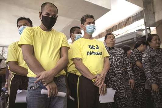 Inmates queue to participate in a drug test at the Quezon City jail in suburban Manila, yesterday.