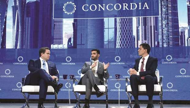 Hassan al-Thawadi with David Miliband and Matthew Swift during the panel discussion.