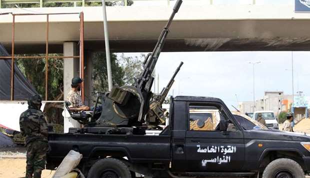 Libyan militiamen loyal to the Government of National Accord (GNA), Libya's internationally recognised government, keep watch from a position south of the Libyan capital Tripoli
