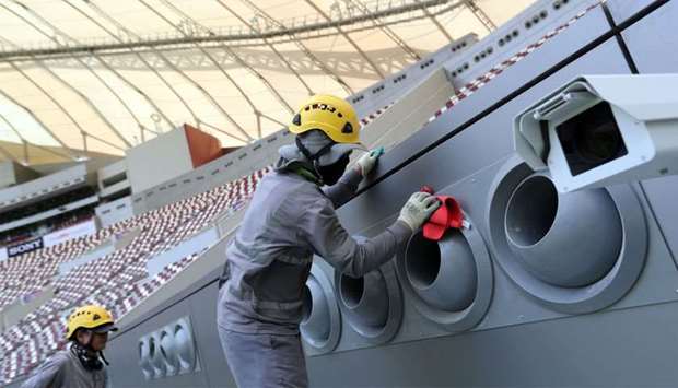 Shows labourers working at a Stadium ahead of the Qatar 2022 FIFA World Cup