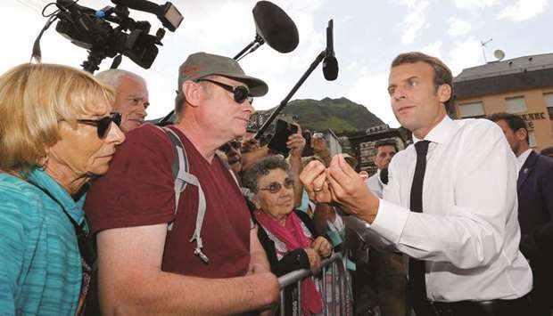 French President Emmanuel Macron stops to speak to people after his visit to the Pic du Midi in the Pyrenees mountains at La Mongie in Bagneres-de-Bigorre, France in this July 26, 2018 file photo.