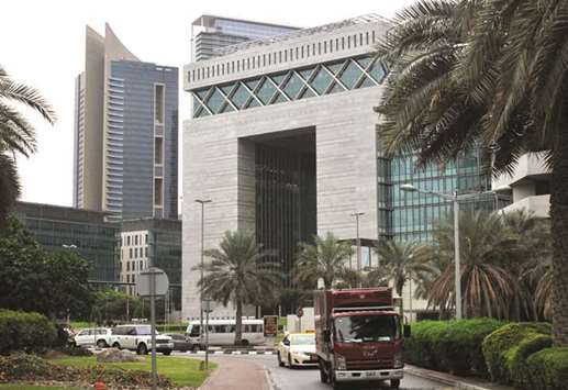 A truck and taxi drive past the Dubai International Financial Centre (DIFC) in Dubai (file). Dubaiu2019s ambition to grow as a Mideast financial hub has taken a blow following Abraaju2019s collapse this year.