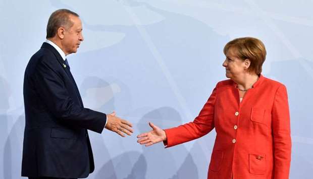 German Chancellor Angela Merkel greets Turkey's President Recep Tayyip Erdogan