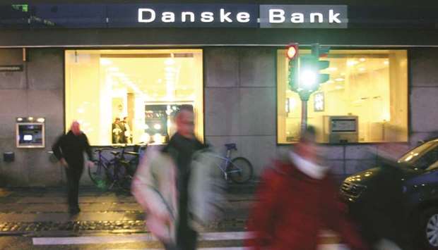 Residents of Copenhagen walk past a Danske Bank branch in the city. Danske has admitted that a large part of about u20ac200bn, or $235bn, that flowed through an Estonian unit between 2007 and 2015 may have been laundered.