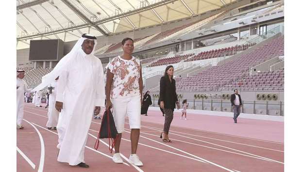 Dahlan al-Hamad, Vice President and Director General of the IAAF World Athletics Championships Local Organising Committee and Vice President of the IAAF, walks with Aretha Thurmond, Managing Director of International & Championship Teams at USA Track & Field (USATF).