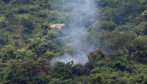 Smoke is seen at the site where two Nigerian military planes were involved in an accident while rehearsing for an air display in Abuja, Nigeria.