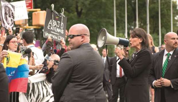 US ambassador to the United Nations Nikki Haley speaks to Venezuelan demonstrators using a loud speaker as they protest against embattled Venezuelan President Nicolas Maduro outside the United Nations headquarters in New York.
