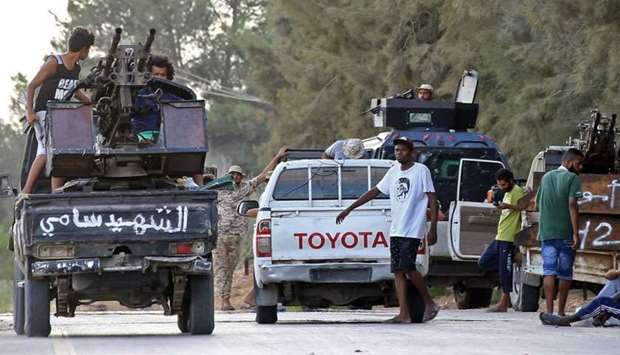 Libyan men loyal to the Government of National Accord (GNA), Libya's internationally recognised government, keep watch from a position south of the Libyan capital Tripoli