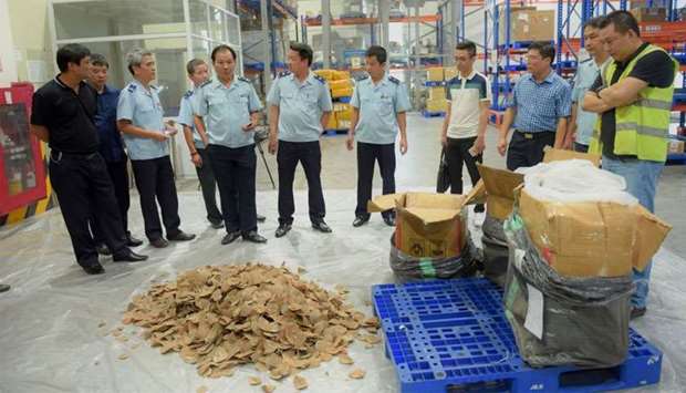 Vietnamese customs officials checking pangolin scales seized in Hanoi.