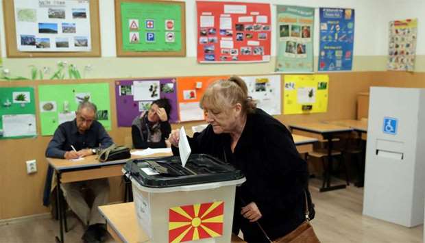 A woman casts her ballot for the referendum in Macedonia on changing the country's name that would open the way for it to join NATO and the European Union in Skopje