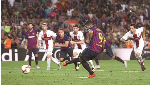 Luis Suarez scores Barcelonau2019s eighth goal from a penalty spot against Huesca in the La Liga at Camp Nou stadium in Barcelona yesterday. (Reuters)