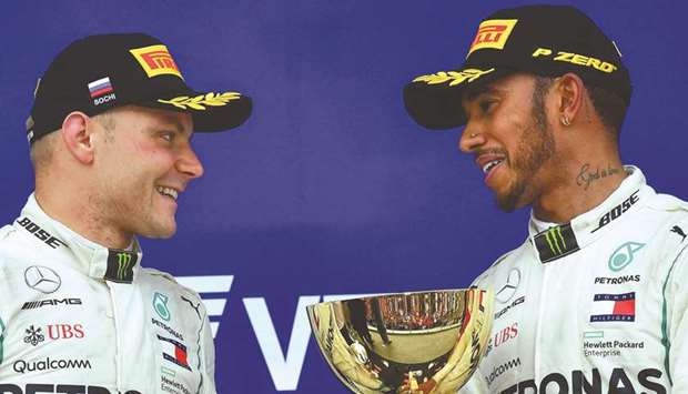 Winner Mercedesu2019 British driver Lewis Hamilton (right) and second-placed Mercedesu2019 Finnish driver Valtteri Bottas celebrate during the podium ceremony for the Formula One Russian Grand Prix at the Sochi Autodrom circuit in Sochi yesterday. (AFP)