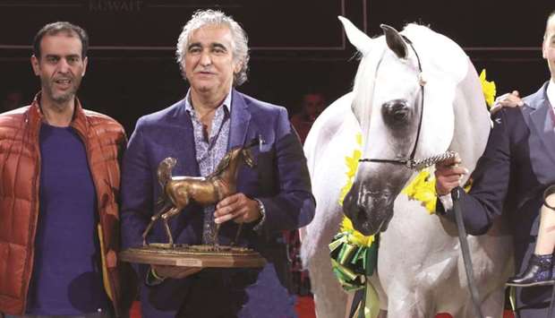 Sheikh Nawaf bin Nasser al-Thani (centre) receives the winneru2019s trophy after Rihab Al Nasser won the Mares Championship gold at the All Nations Cup Arabian horse show in Aachen, Germany, yesterday.