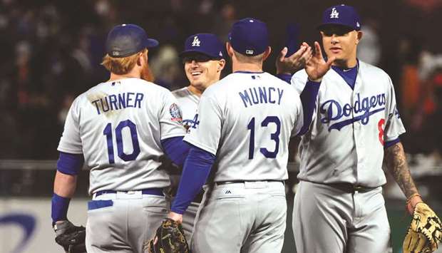 Los Angeles Dodgers third baseman Justin Turner, right fielder Enrique Hernandez (second left), first baseman Max Muncy and shortstop Manny Machado celebrate after their win against the San Francisco Giants at AT&T Park. PICTURE: USA TODAY Sports