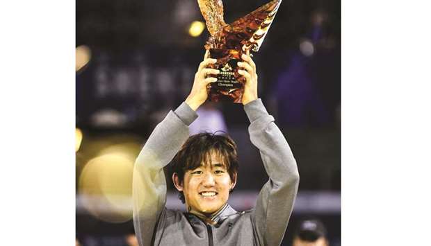 Yoshihito Nishioka of Japan celebrates with the trophy after winning the Shenzhen Open yesterday. (AFP)