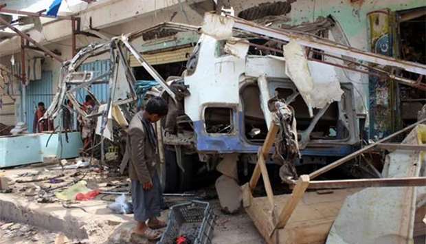 A Yemeni child stands next to the destroyed bus at the site of a Saudi-led coalition air strike last month. File picture