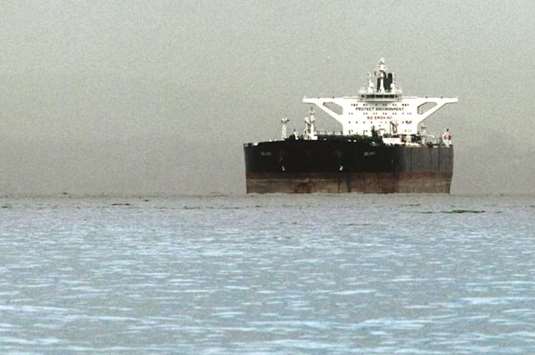 Iranian crude oil supertanker u201cDelvaru201d is seen anchored off Singapore. Indiau2019s attempt to keep Iranian oil flowing mirrors a step by China, where buyers are shifting nearly all their Iranian oil imports to vessels owned by National Iranian Tanker Co. The moves by the two top buyers of Iranian crude indicate that the Islamic Republic may not be fully cut off from global oil markets from November, when US sanctions against Tehranu2019s petroleum sector are due to start.
