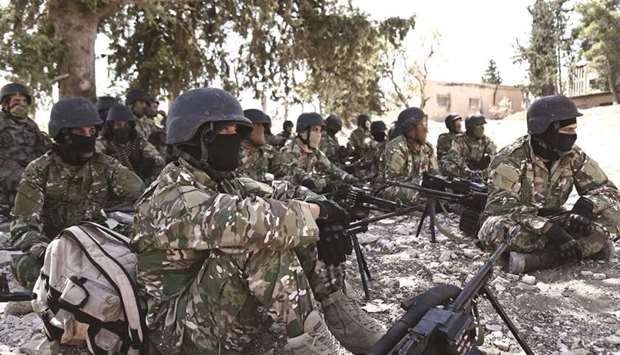 Fighters of the National Liberation Front prepare in anticipation of an attack by the regime on Idlib province and the surrounding countryside, near Idlib, yesterday.