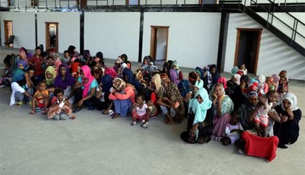 Migrants are seen in a shelter after they were relocated from government-run detention centres, in Tripoli last week.