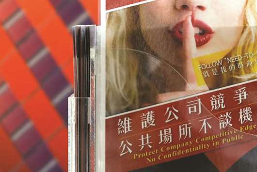 A leaflet that asks employees to protect company confidentiality is seen at a  reception in a chip company, in Hsinchu, Taiwan. Chinese chip makers are offering Taiwan engineers a huge pay rise, eight free trips home a year and a heavily subsidised apartment.