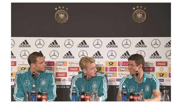 Germanyu2019s (from left) goalkeeper Manuel Neuer, midfielders Julian Brandt and Thomas Mueller attend a press conference in Munich yesterday, on the eve of their UEFA Nations League match. (AFP)