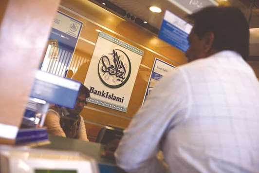 A BankIslami Pakistan logo is displayed at a branch in Karachi (file). Share of Islamic banking assets and deposits in the overall industry has been recorded at 12.9% and 14.8%, according to the State Banku2019s Islamic Banking Bulletin for June 2018  issued yesterday.
