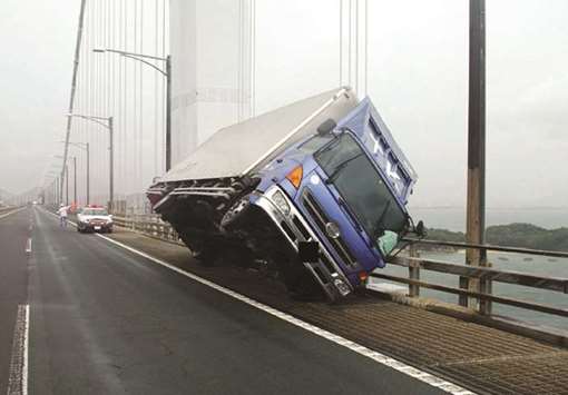 A truck sitting at an angle after being blown over by strong winds caused by Typhoon Jebi on the Seto Ohashi bridge in Sakade, Kagawa prefecture, on Japanu2019s Shikoku island.