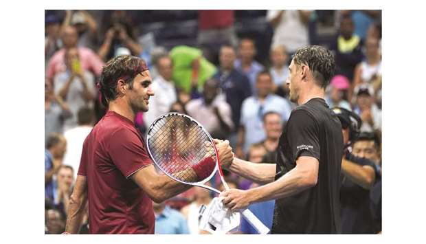 Australiau2019s John Millman (right) shakes hands with Switzerlandu2019s Roger Federer after defeating him on Monday. (AFP)